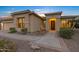 Well-lit entrance to a single-story home with a decorative fountain at 42929 W Castle Cove Cir, Maricopa, AZ 85138