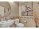 Small powder room with a pedestal sink and toilet at 42929 W Castle Cove Cir, Maricopa, AZ 85138