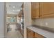 View of kitchen with light wood cabinets and gray countertops at 42929 W Castle Cove Cir, Maricopa, AZ 85138