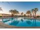 Expansive community pool at sunset at 42929 W Castle Cove Cir, Maricopa, AZ 85138