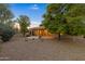 Landscaped backyard with gravel and mature trees at 42929 W Castle Cove Cir, Maricopa, AZ 85138