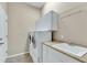 Laundry room with washer, dryer, and cabinets at 42929 W Castle Cove Cir, Maricopa, AZ 85138