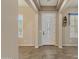 Bright and spacious entryway with tile flooring and a white door at 42929 W Castle Cove Cir, Maricopa, AZ 85138