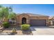 Single-story home with desert landscaping and a two-car garage at 42057 W Manderas Ln, Maricopa, AZ 85138