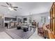 Open living area with gray sofa, kitchen island, and dining table at 42057 W Manderas Ln, Maricopa, AZ 85138