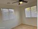 Bright bedroom with two windows and tile floors at 4502 W Crittenden Ln, Phoenix, AZ 85031