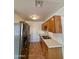 Kitchen with stainless steel refrigerator and wood cabinets at 4502 W Crittenden Ln, Phoenix, AZ 85031