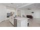 Kitchen with island, stainless steel appliances, and view of living room at 22207 N Daniel Dr, Maricopa, AZ 85138