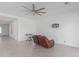 Living room with ceiling fan and access to hallway at 22207 N Daniel Dr, Maricopa, AZ 85138