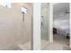 Clean bathroom with a walk-in shower and tiled walls at 22207 N Daniel Dr, Maricopa, AZ 85138