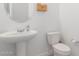 Clean bathroom with pedestal sink and toilet at 22207 N Daniel Dr, Maricopa, AZ 85138