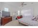 Bright bedroom with large bed, dresser, and work space at 22207 N Daniel Dr, Maricopa, AZ 85138