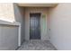 Covered entryway with gray door and tile flooring at 22207 N Daniel Dr, Maricopa, AZ 85138