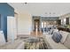 Open living room features hardwood floors, modern kitchen with island, and neutral color palette at 5725 S 101St St, Mesa, AZ 85212