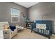 Charming Bedroom with crib, recliner, and bookshelf at 5725 S 101St St, Mesa, AZ 85212