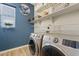 Bright laundry room with washer, dryer, and ample shelving at 5725 S 101St St, Mesa, AZ 85212