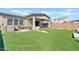 Artificial turf backyard with covered patio, seating area, and play equipment at 5725 S 101St St, Mesa, AZ 85212