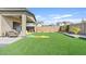 Artificial turf backyard with covered patio and seating area at 5725 S 101St St, Mesa, AZ 85212