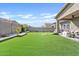 Landscaped backyard with artificial turf, covered patio, and seating area at 5725 S 101St St, Mesa, AZ 85212