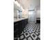 Black and white bathroom with double vanity and walk in shower at 31214 N 167Th Ave, Surprise, AZ 85387