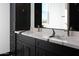 Double vanity bathroom with black cabinets and marble countertop at 31214 N 167Th Ave, Surprise, AZ 85387