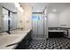 Modern bathroom with black and white tile and double vanity at 31214 N 167Th Ave, Surprise, AZ 85387