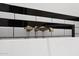Bathroom detail featuring a modern, metallic faucet and black and white tile at 31214 N 167Th Ave, Surprise, AZ 85387