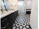 Elegant bathroom with black and white tile, double vanity, and free-standing tub at 31214 N 167Th Ave, Surprise, AZ 85387