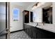 Elegant bathroom with double vanity and patterned floor at 31214 N 167Th Ave, Surprise, AZ 85387