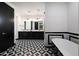Bathroom with black and white tile and double vanity at 31214 N 167Th Ave, Surprise, AZ 85387