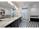 Modern bathroom with black and white tile and a soaking tub at 31214 N 167Th Ave, Surprise, AZ 85387