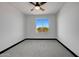 Spacious bedroom with grey carpet and a large window at 31214 N 167Th Ave, Surprise, AZ 85387
