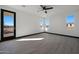 Bedroom with wood-look floors and access to patio at 31214 N 167Th Ave, Surprise, AZ 85387