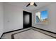 Bright bedroom with grey carpet, large window, and a ceiling fan at 31214 N 167Th Ave, Surprise, AZ 85387