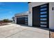 Two-car garage with modern black door and windows at 31214 N 167Th Ave, Surprise, AZ 85387