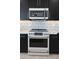 Modern kitchen with white appliances and marble countertops at 31214 N 167Th Ave, Surprise, AZ 85387