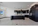 Open concept kitchen with dark cabinetry, marble countertops, and breakfast bar at 31214 N 167Th Ave, Surprise, AZ 85387