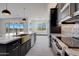 Modern kitchen with farmhouse sink, marble countertops and stainless steel appliances at 31214 N 167Th Ave, Surprise, AZ 85387