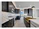 Modern kitchen with gold sink, white cabinets and marble countertops at 31214 N 167Th Ave, Surprise, AZ 85387