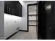 Laundry Room with black cabinets and access to a large closet at 31214 N 167Th Ave, Surprise, AZ 85387