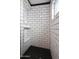 Shower with black and white tile and built in seat at 31214 N 167Th Ave, Surprise, AZ 85387