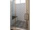 Walk in shower with black and white tile and built in seat at 31214 N 167Th Ave, Surprise, AZ 85387