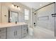 Bathroom with gray vanity, patterned tile, and bathtub at 31224 N 167Th Ave, Surprise, AZ 85387