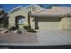 Tan colored house with a two car garage and desert landscaping at 5830 E Mckellips Rd # 62, Mesa, AZ 85215