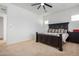 Bright bedroom with a king-size bed, neutral color palette, and ceiling fan at 28389 N 131St Dr, Peoria, AZ 85383