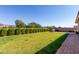 Landscaped backyard with built-in grill and grassy area at 28389 N 131St Dr, Peoria, AZ 85383