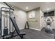 Home gym with various exercise equipment including weight machine and elliptical at 42930 N Voyage Trl, Phoenix, AZ 85086