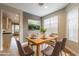 Modern dining room with a wood table and access to the kitchen at 42930 N Voyage Trl, Phoenix, AZ 85086