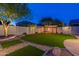 Landscaped backyard featuring a pergola, artificial turf, and mature trees at 42930 N Voyage Trl, Phoenix, AZ 85086