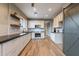 Open concept kitchen with white cabinets, dark countertops, and a barn door at 42930 N Voyage Trl, Phoenix, AZ 85086